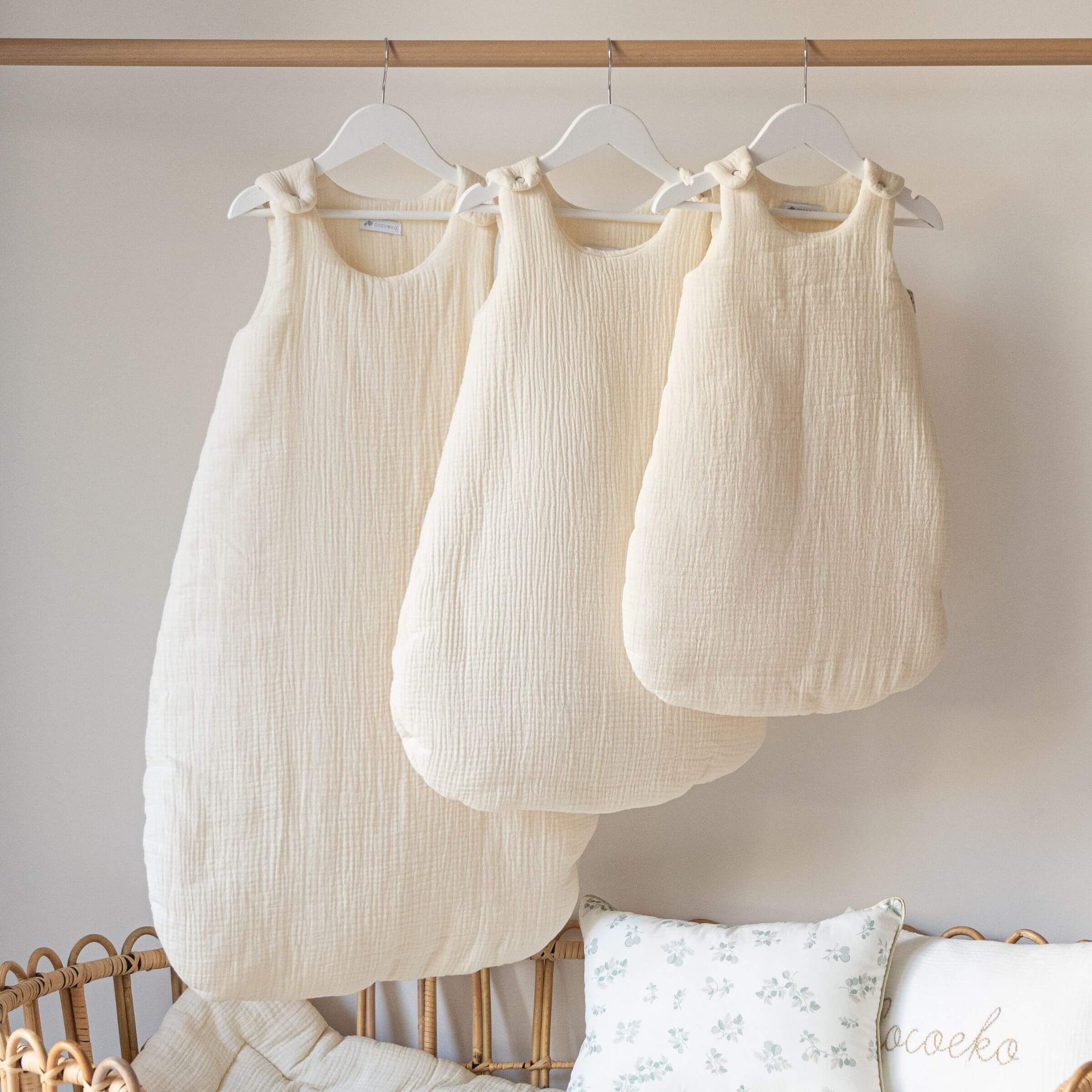 Ecru cotton gauze sleeping bags 0-6 months, 06-24 months and 24-36 months in a nursery