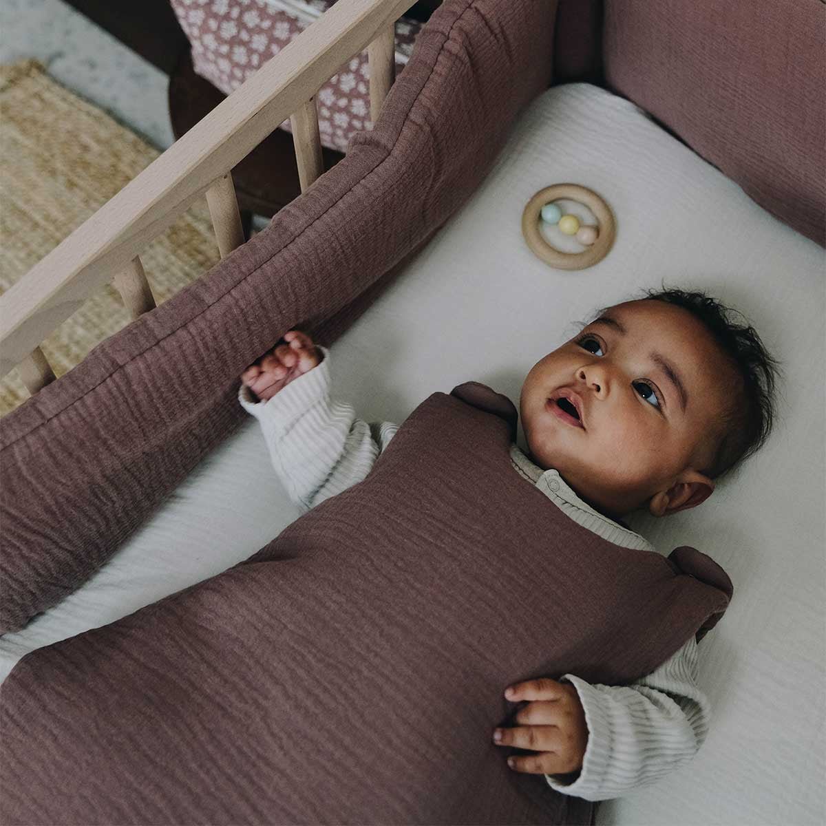 Chestnut crib bumper in a crib