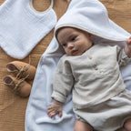 Baby in a bamboo sponge bath cape
