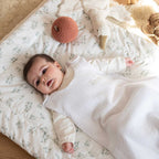 Baby wearing a white summer sleeping bag