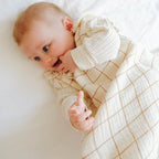 Baby with summer sleeping bag in check cotton gauze