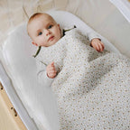 Baby with flowered sleeping bag tog 2