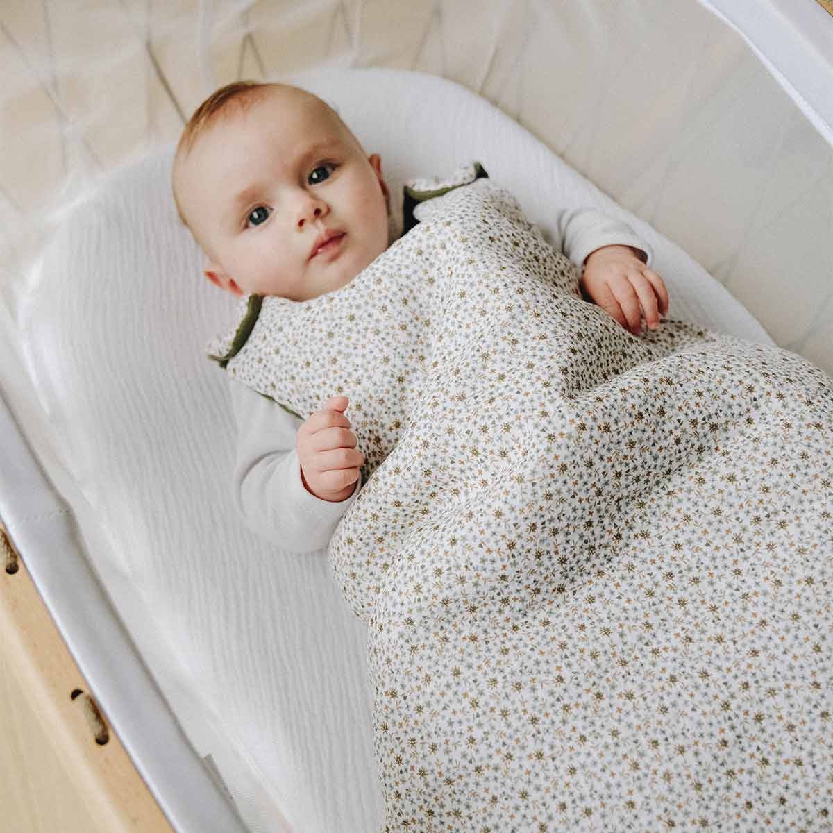 Baby with flowered sleeping bag tog 2