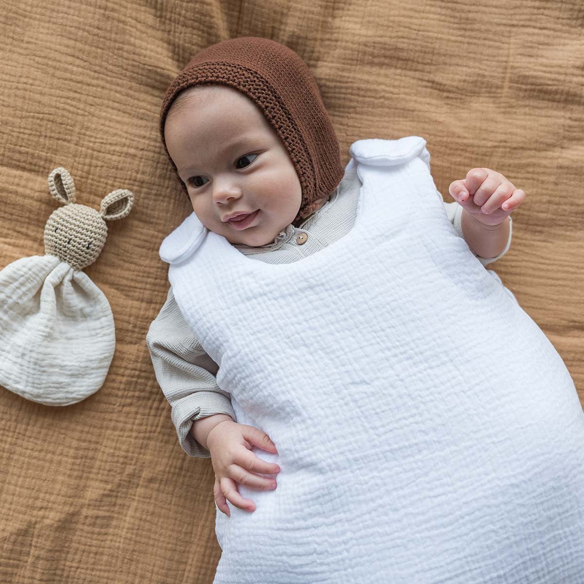Baby in white sleeping bag