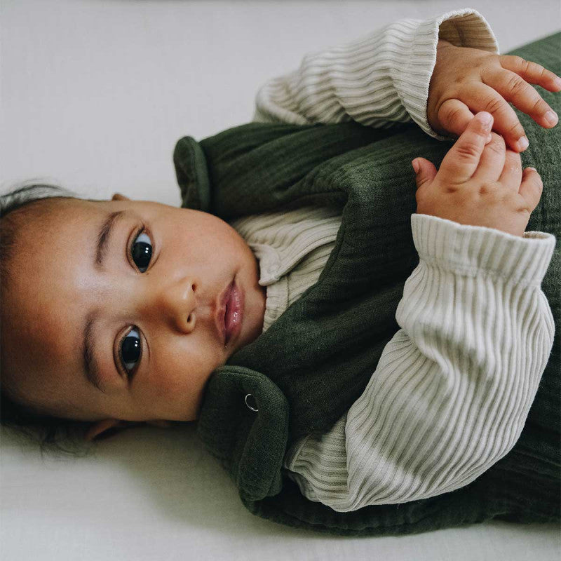 Baby in a fern-green sleeping bag