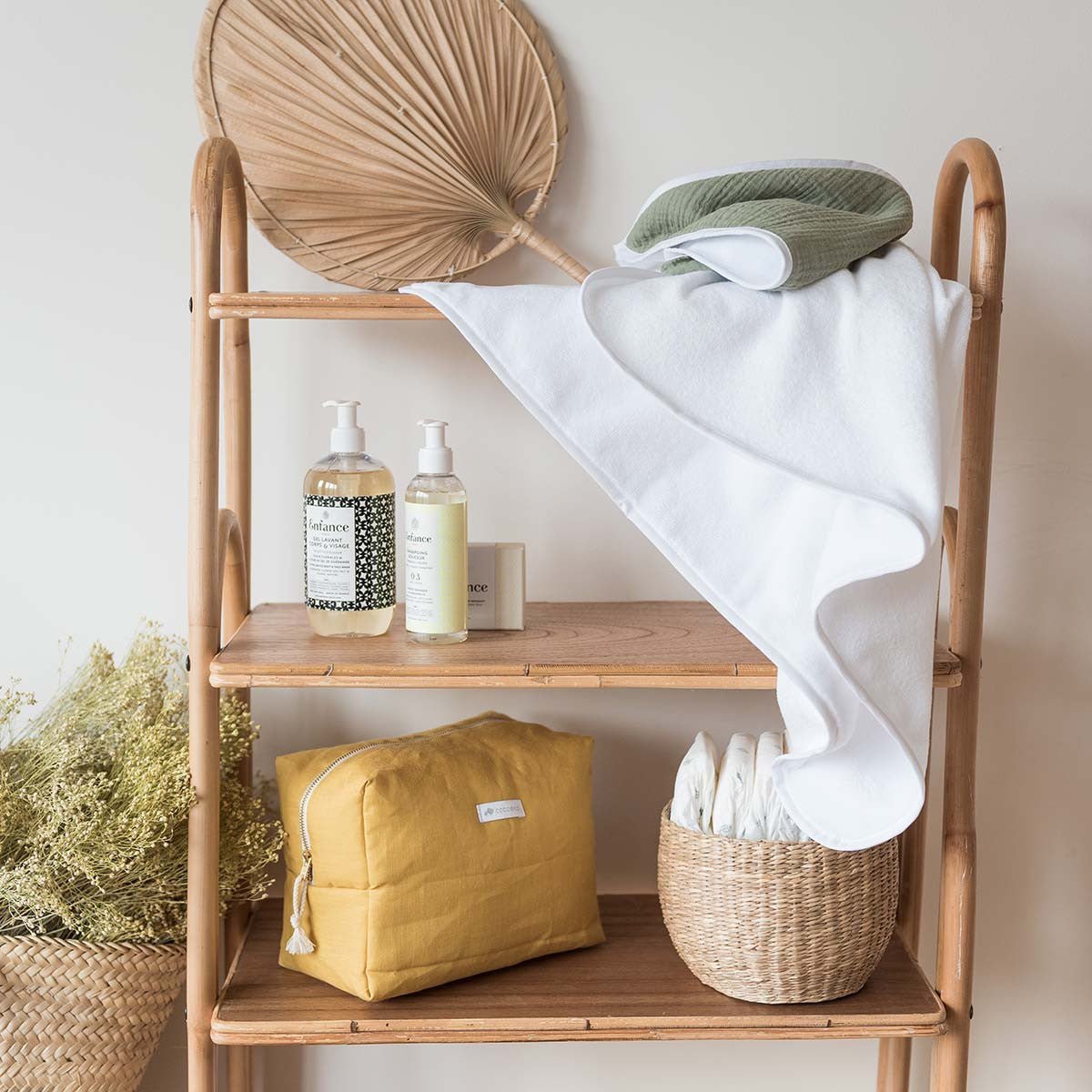 Sage green bath cape on a shelf
