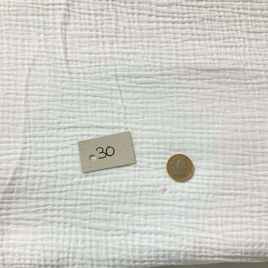 Defect in the gauze on the white knotted curtain