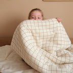 Child playing with a sleeping bag
