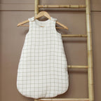 Cotton gauze sleeping bag with green check pattern for a baby's nursery