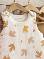 Winter sleeping bag in ecru with bird design in a cot with comforter