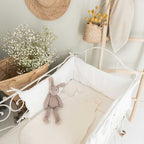 Ecru tog 1 sleeping bag in a crib