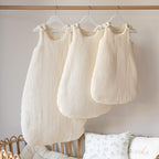Ecru cotton gauze sleeping bags 0-6 months, 06-24 months and 24-36 months in a nursery