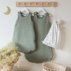 Sage green cotton gauze sleeping bags in a nursery