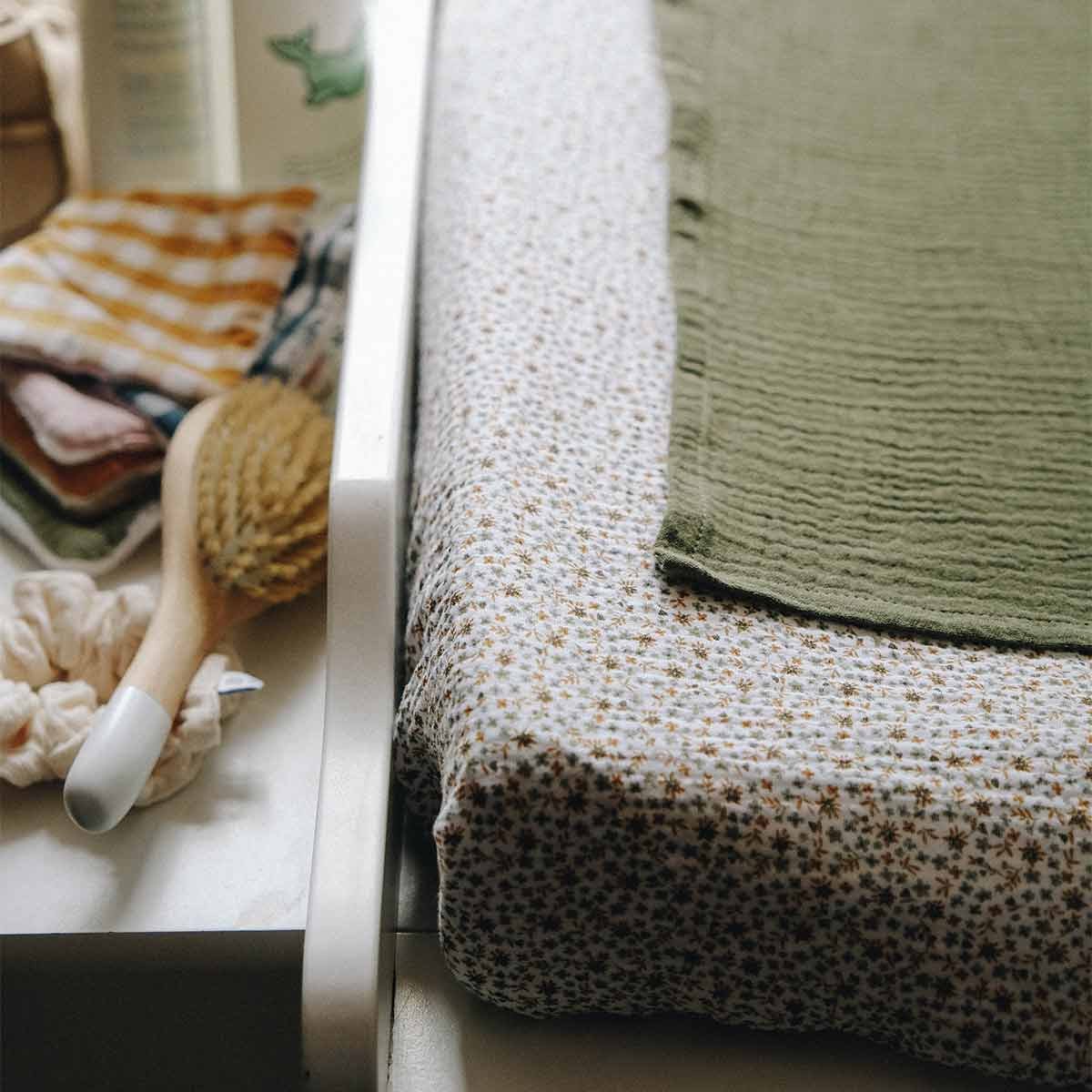 Changing mat cover in cotton gauze, fern flowers, close-up view