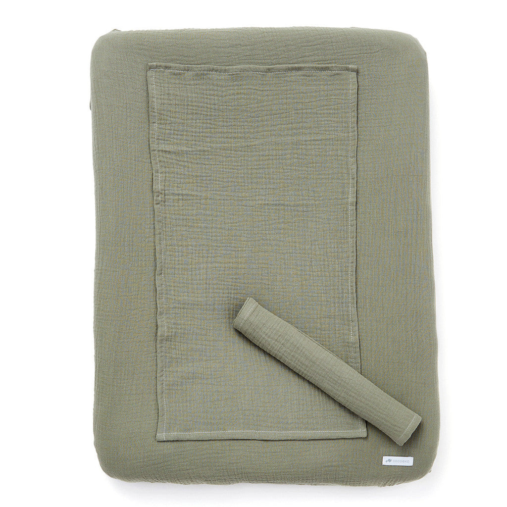 Changing mat cover in sage green cotton gauze
