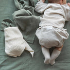 Sage green diaper with a baby