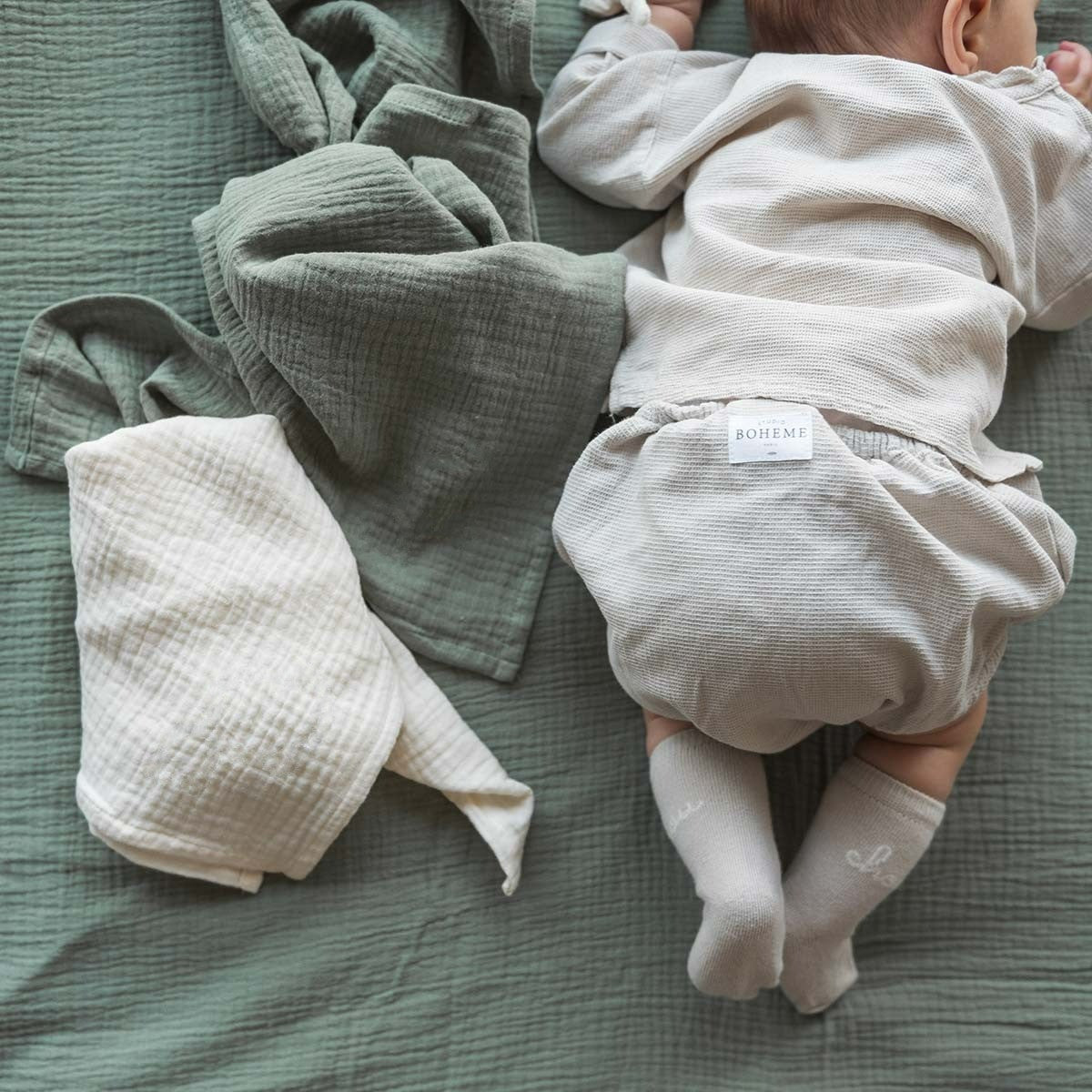 Sage green diaper with a baby
