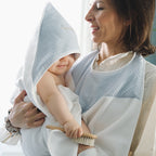 Mom and baby in an apron bath cape