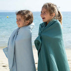 Two girls covered in ice blue and eucalyptus coloured maxi diapers