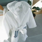 White and gingham baby bathrobe close-up