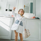 White and gingham children's bathrobe worn by a little boy