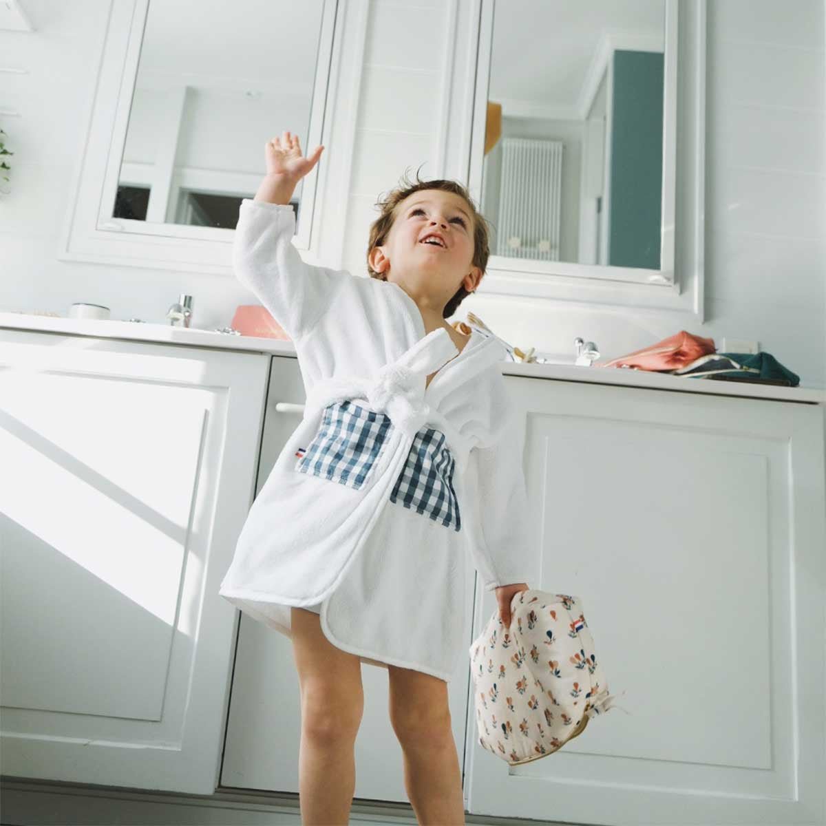 White and gingham children's bathrobe worn by a little boy