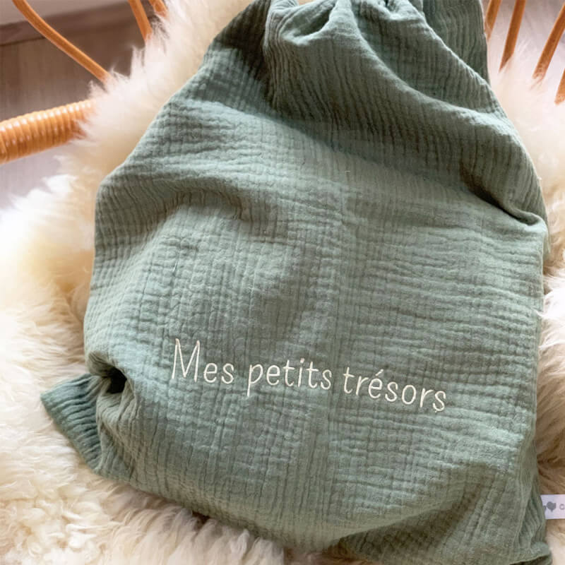 Focus on the customizable sage green cotton gauze pouch