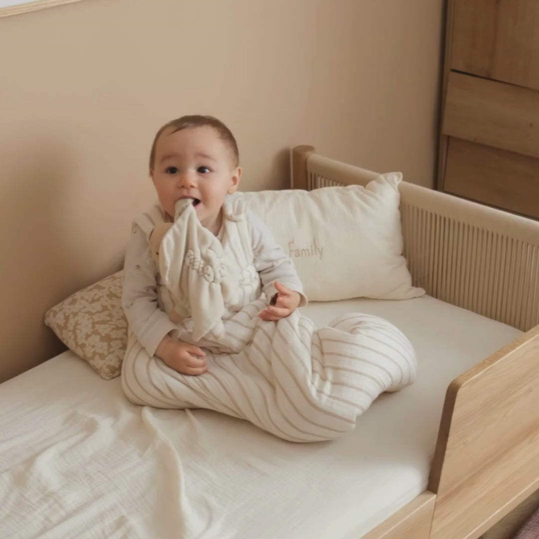 baby with beige striped sleeping bag tog 2