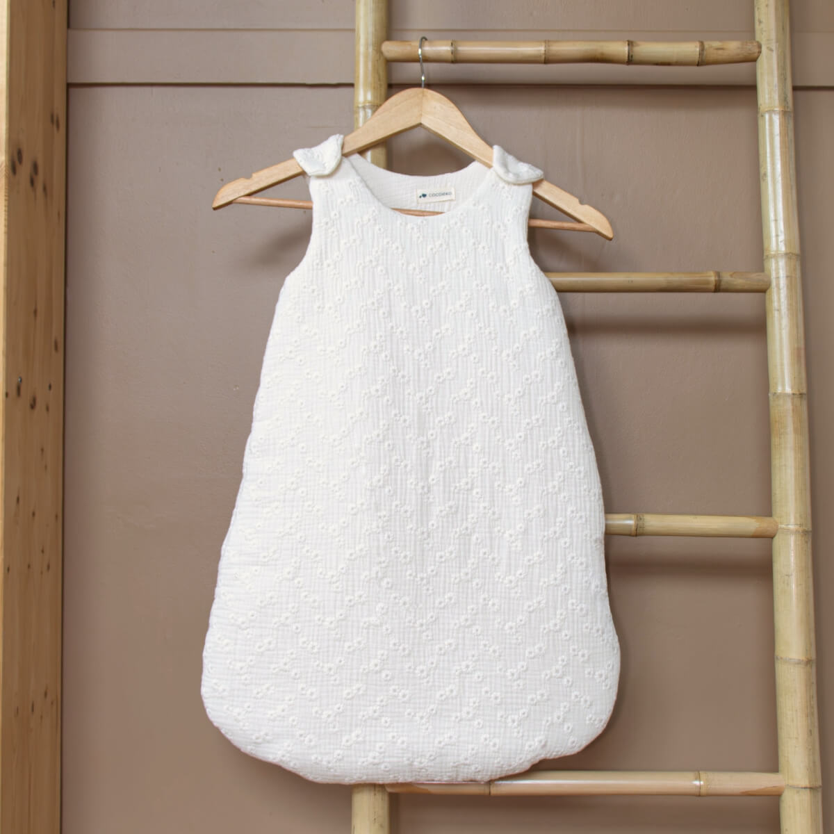 Winter sleeping bag with ecru embroidery in baby room