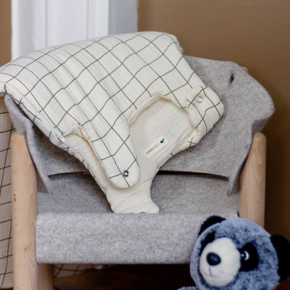 Ecru turbulette with sage green checks on a child's chair with comforter