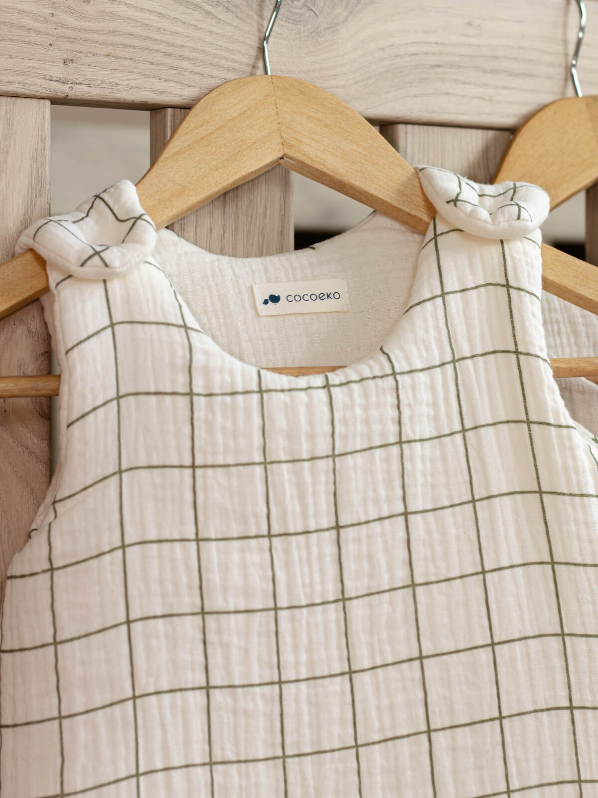 Cotton gauze sleeping bag with green check pattern, close-up view