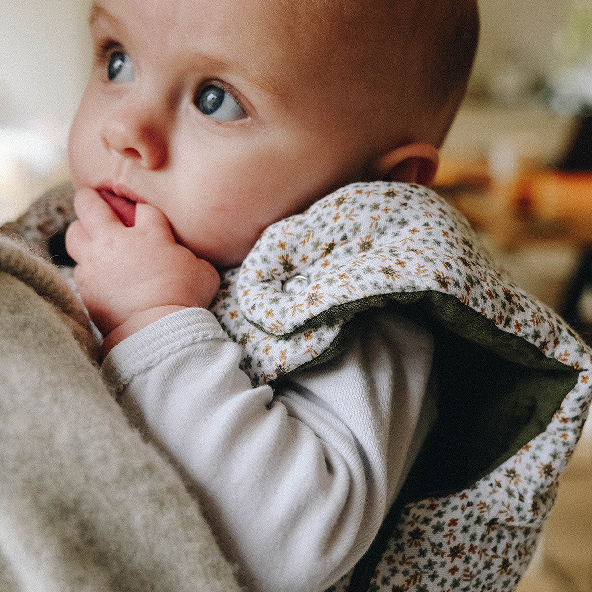Baby in flowered sleeping bag, close-up view